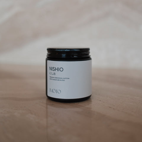 Small cylindrical container with a white label on a light wooden surface